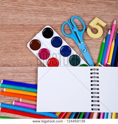 Paints, brushes, scissors, markers, colored pencils and album - drawing tools on the table