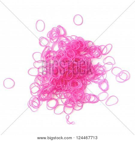 Pile of pink rubber loom bands isolated over the white background