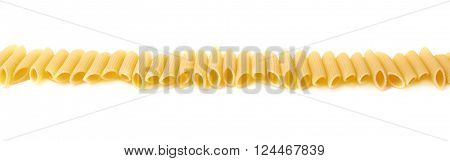 Multiple dried yellow penne pasta noodles lined up in a row, composition isolated over the white background
