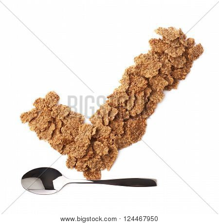 Yes tick sign symbol mark made of whole grain cereal flakes over the metal tea spoon, composition isolated over the white background