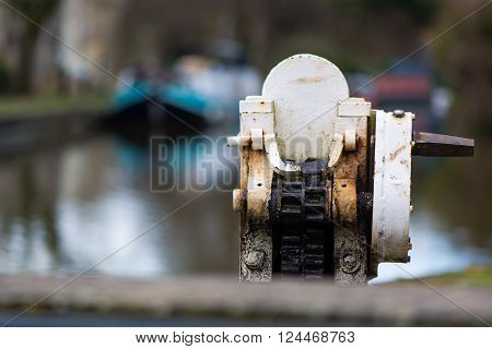 Gear mechanism for canal lock. A mechanism for opening a lock gate on the Kennet and Avon canal, with narrow boats in background
