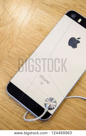 PARIS FRANCE - APR 4 2016: Rear view of the new Apple iPhone SE during the sales launch of the latest Apple Inc. smartphone and iPad Pro at the Apple store in Paris France