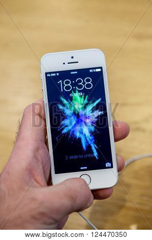 PARIS FRANCE - APR 4 2016: Unlocking iPhone the new Apple iPhone SE during the sales launch of the latest Apple Inc. smartphone and iPad Pro at the Apple store in Paris France