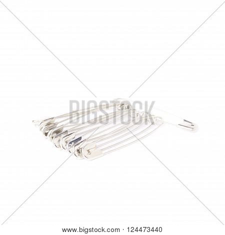 Bunch of metal safety pins isolated on white background