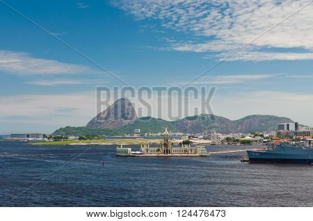 Rio de Janeiro Brazil - December 20 2012: Ilha Fiscal in the foreground is an island located within Guanabara Bay bordering the historic city center of Rio de Janeiro in Brazil. Santos Dumont Airport in the center. Sugarloaf in the background.