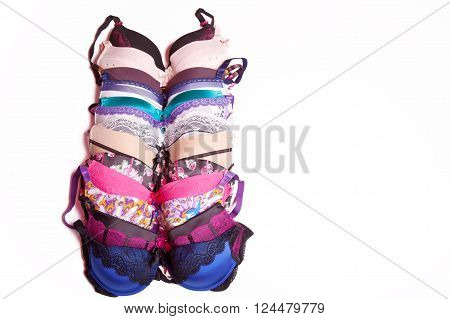 A lot of beautiful bright multi-colored bra on white background