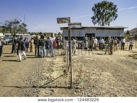 LALIBELA ETHIOPIA - AUG 1 1998: people at airport in Lalibela Ethiopia. Arrival and departure is an open air sector with a hut to protect against sun.