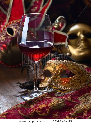 Old golden Venetian masks and red wine