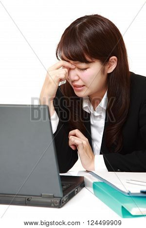 portrait of young Japanese businesswoman suffers from Asthenopia