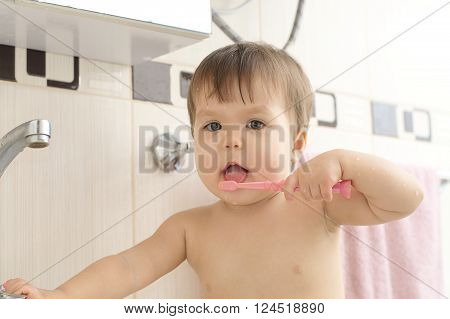 Child Cleaning Teeth In Bathroom