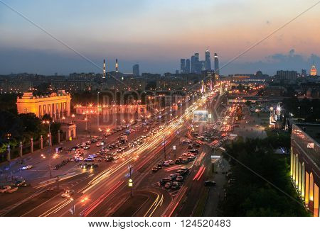 Krymsky Val Street, traffic, entrance arch in Gorky Park in Moscow night, Russia