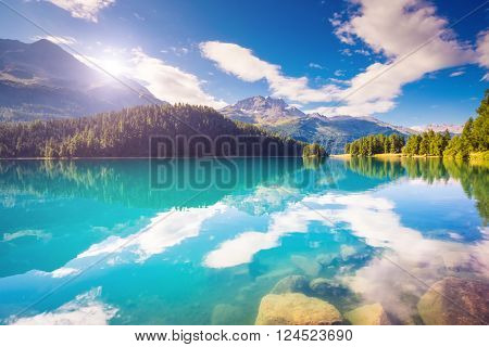 Fantastic view of the azure pond Champfer. Picturesque scene. Location: resort Silvaplana village, district of Maloja in the Swiss canton of Graubunden, Alps. Europe. Artistic picture. Beauty world.