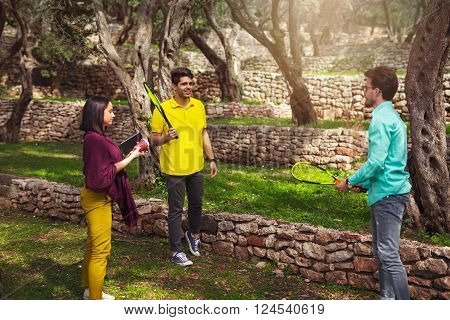 Three young people playing speedminton - badminton