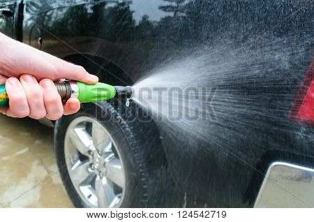Spraying Vehicle With Water ready For Car Wash