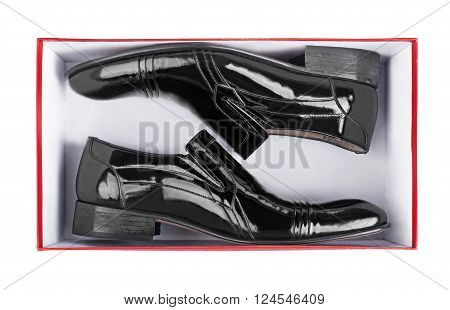 Pair of black leather shoes inside a box