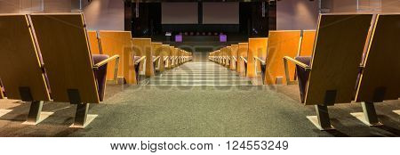 Photo of corridor between seats in spacious lecture hall in modern college