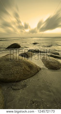 View of a rocky coast during sunset. Long exposure shot