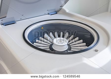 White centrifugal machine with the lid open