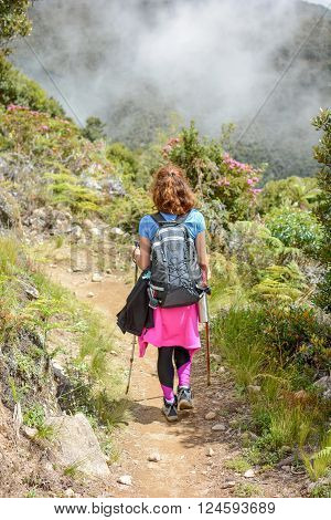 female mountaineer descending down a steep trail