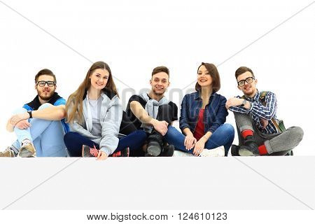 Causal group of people sitting on the floor isolated