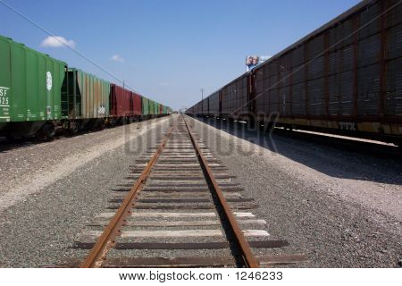 Two Trains Heading Towards The Horizon.