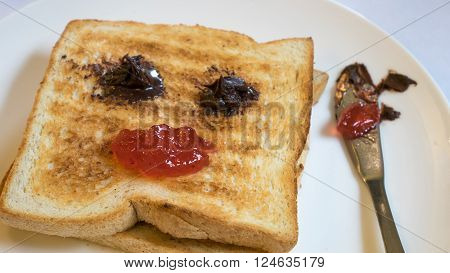 The close up of tasty bread toast and strawberry jam with chocolate spread on white plate.