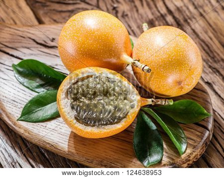 Granadilla fruits on the wooden table.