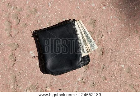 purse on the ground with money. Lost wallet