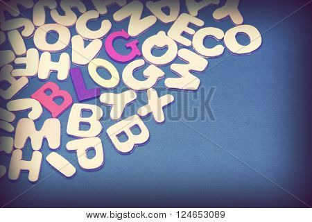 Blog Colored Sign Among Different Uncolored Letters On Green Background Top View Close Up