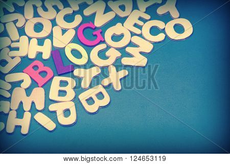 Blog Colored Sign Among Different Uncolored Letters On Green Background Top View Close Up