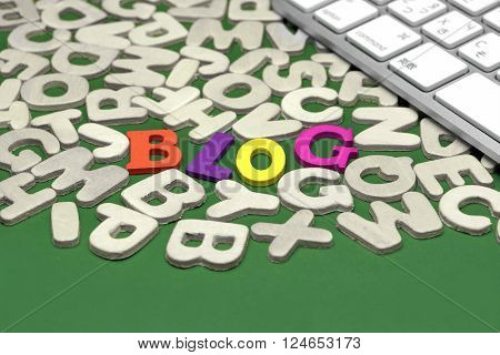 Blog Colored Sign Among Different Uncolored Letters On Green Background Top View Close Up