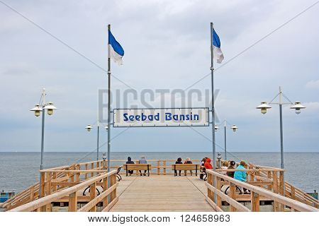 Bansin Usedom Germany - June 27 2012: Pier of the baltic sea spa town Bansin - a famous tourist hotspot. Pier sign labeled with sea spa town Bansin (Seebad Bansin).