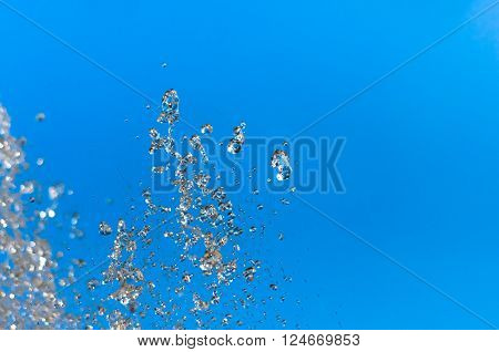 Water fountain on a background of blue sky