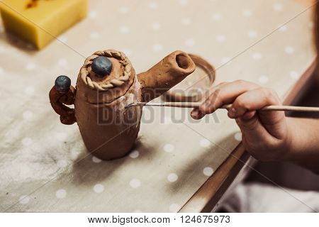 children's hands sculpts clay crafts pottery school