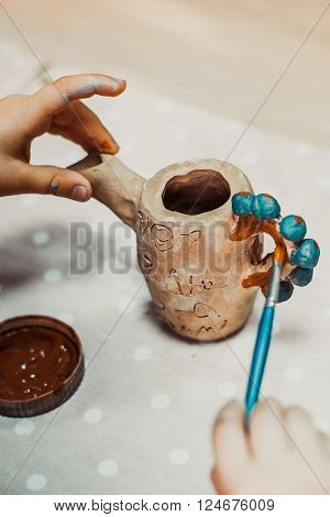children's hands sculpts clay crafts pottery school
