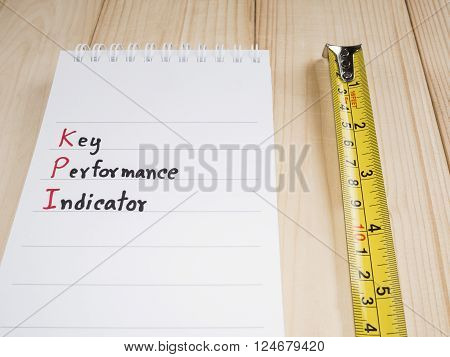 KPI (Key Performance Indicator) with wood background (Business concept)