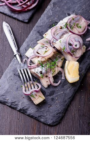 Sliced Herring On A Black Slate Plate