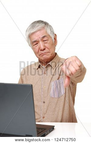 senior Japanese man using computer looking confused