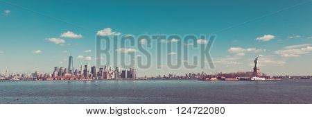 New York City is viewed on a beautiful day from Liberty State Park in Jersey City New Jersey. 432 Park Freedom Tower Ellis Island Brooklyn and the Statue of Liberty are all seen in this sweeping panorama.