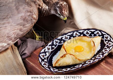 khachapuri  ajarian meal oriental plate with egg on a white background top menu Uzbek dishes stuffed eagle, taxidermy,