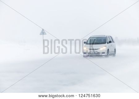 NOVYY URENGOY, RUSSIA - MARCH 20, 2016: Family van Toyota Previa at the interurban freeway during a heavy northern blizzard.