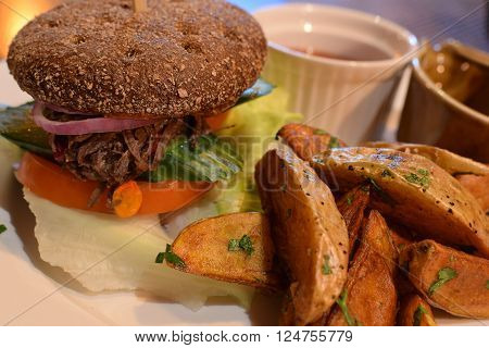 Shredded Beef Sandwich on a dark bun
