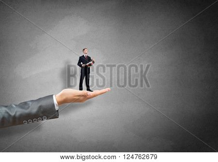 Big female palm holding small confident businessman play drum