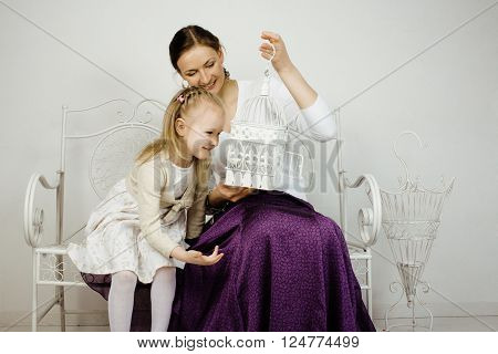 young mother with daughter at luxury home interior vintage, old fashion relashionship family