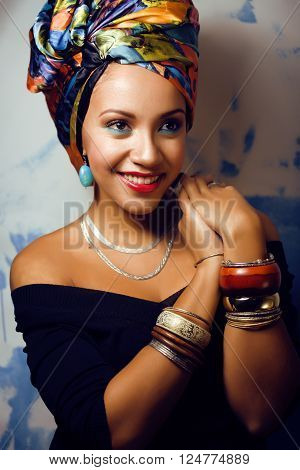 beauty bright real african woman with creative make up, shawl on head like cubian closeup smiling
