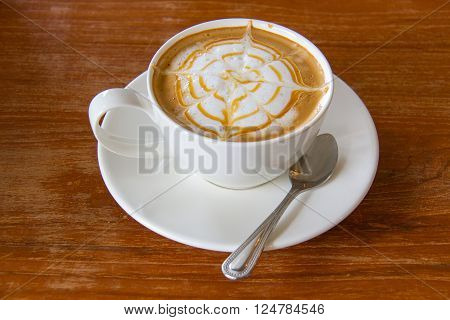 Cup of cappuccino coffee on wooden table
