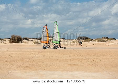 Corralejo Fuerteventura Spain - Spetember 15 2015: People Driving Sand Yachting On The Beach. They A
