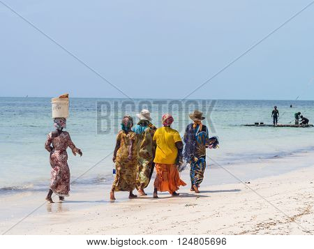 PAJE, ZANZIBAR - MARCH 30, 2016: Local women going fishing on a beach in Zanzibar, Tanzania.