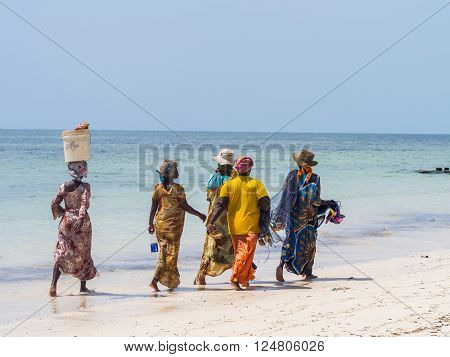 PAJE, ZANZIBAR - MARCH 30, 2016: Local women going fishing on a beach in Zanzibar, Tanzania.