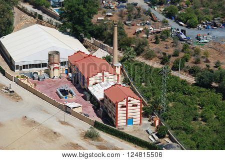 ALORA, SPAIN - JUNE 27, 2008 - Elevated view of an old fashioned factory with chimney in valley Alora Malaga Province Andalucia Spain Western Europe, June 27, 2008.